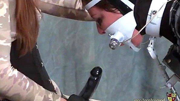 Скованную рабыню трахают страпоном в ротик